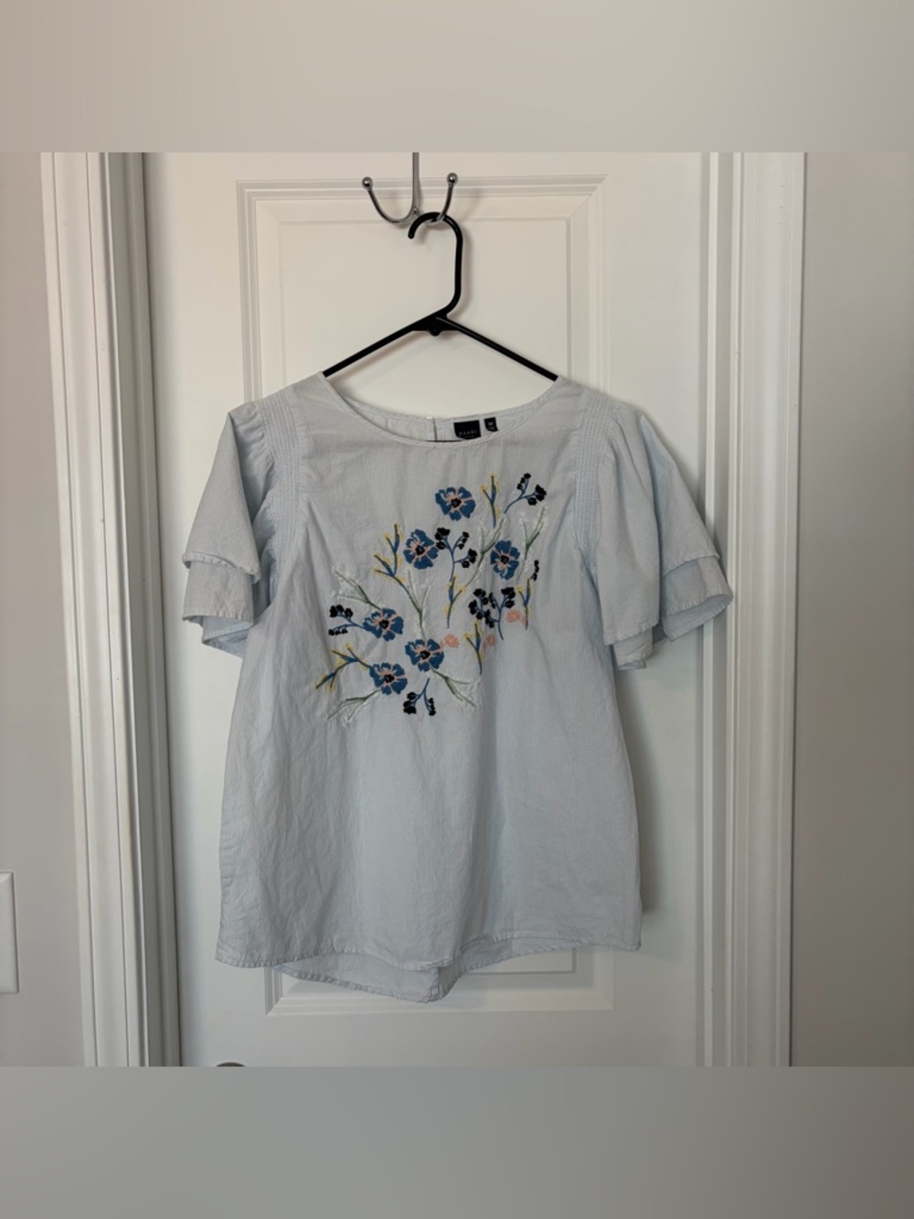 Kaari Blue- Embroidered Light Blue Floral Ruffle Sleeve Blouse
Size M